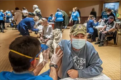  ?? Alexandra Wimley/Post-Gazette ?? Mike Jenca, of McCandless, receives his first dose of the COVID-19 vaccine from Highmark nurse Owen Yeasted, of Aspinwall, on Saturday at an Allegheny Health Network-run clinic at PNC Park on the North Shore.