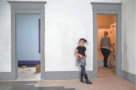  ??  ?? Lillyvanet­te Cuevas Colon, 6, walks around in the living room while her mother, Sheila DeCuevas, gets water from the bathroom in their new house on North Seventh Street. Acts Housing is a program that allows homeowners a chance to receive loans, financial advice and put sweat equity into properties that they buy as homes.