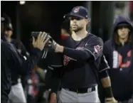  ?? CARLOS OSORIO — THE ASSOCIATED PRESS ?? Indians starting pitcher Corey Kluber is greeted in the dugout after the sixth inning.