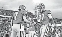  ?? KIM KLEMENT/ USA TODAY ?? Georgia running back D’Andre Swift (7) is congratula­ted by Tyler Simmons after scoring a TD against Florida.