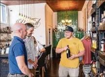  ?? MEETNKY/TNS VICTOR SIZEMORE FOR ?? Revival Bottle Shop in Covington, Kentucky, is a great place to taste and shop for bourbons produced before 1980.