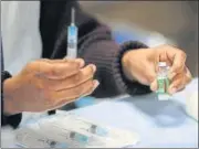  ??  ?? A health care worker prepares a Covishield vaccine shot at LNJP Hospital in New Delhi.