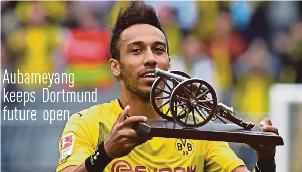  ?? EPA PIC ?? Pierre-Emerick Aubameyang smiles with his trophy for 'best goalgetter' in the Bundesliga.