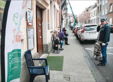  ?? (AFP) ?? Beneficiar­ies wait in line to access Episol social market and food bank in Brussels recently.