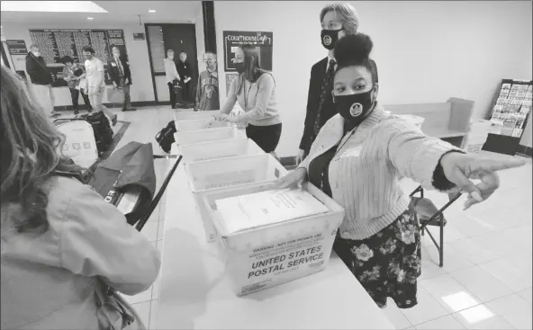  ?? ASSOCIATED PRESS ?? MARIAN COLLIN FRANCO, 20, HELPS COLLECT provisiona­l ballots at the Erie County Courthouse on Election Day on Tuesday in Erie, Pa.