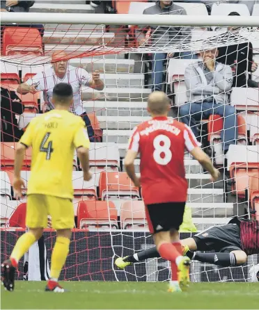  ??  ?? Jon Mclaughlin makes a penalty save from Paddy Madden.