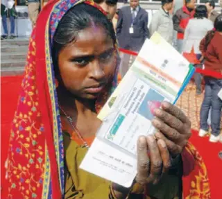  ??  ?? A woman showing her unique ID card