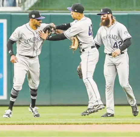  ??  ?? From left, Rockies’ left fielder Ian Desmond (game-winning homer), right fielder Carlos Gonzalez (RBI single), and center fielder Charlie Blackmon (home run, double, three RBIs) celebrate their win over the Nationals on Sunday.