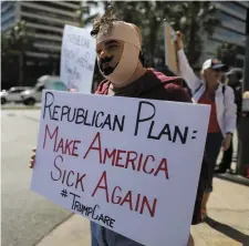  ??  ?? Rob Adler protests in Los Angeles yesterday against President Trump’s proposed replacemen­t for Obamacare