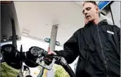  ?? DON RYAN/AP 2015 ?? Station attendant James Lewis pumps gas at a Portland, Ore., station. Oregon and New Jersey require attendants.