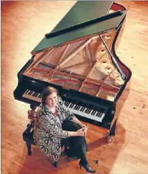  ??  ?? Sound choice: Elizabeth Hudson with the School of Music’s new Steinway. She and two others flew to Germany to choose the piano for the Adam Concert Room.