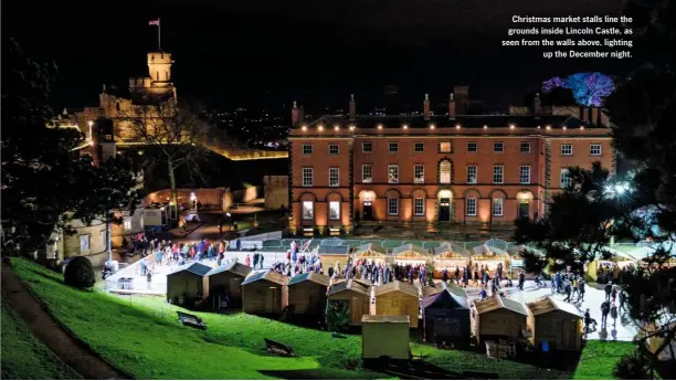  ??  ?? Christmas market stalls line the grounds inside Lincoln Castle, as seen from the walls above, lighting up the December night.