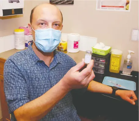  ?? BRENDAN MILLER ?? Jason Kmet, with a dose of Astrazenec­a vaccine, says the Polaris Travel Clinic and Pharmacy in Airdrie can handle many more doses.