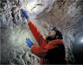  ?? KIM RAFF/THE NEW YORK TIMES ?? Nate Fuller, a postdoctor­al biologist from Texas Tech, collects a bat in an abandoned mining cave near Ely, Nev., on Nov. 5. Biologists are searching caves and abandoned mines in the West, hoping to spare many species of the winged creatures from the devastatin­g fungus, white-nose syndrome.