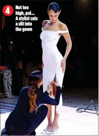  ?? ?? Not too
4 high, pal… A stylist cuts a slit into the gown