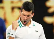  ?? AP Photos/Andy Brownbill ?? ■ RIGHT: Serbia’s Novak Djokovic celebrates after defeating Russia’s Aslan Karatsev in their semifinal match Thursday in Melbourne.