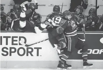  ?? TROY FLEECE ?? One Memorial Cup highlight: Regina’s Liam Schioler, left, landing in the Swift Current bench.