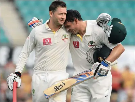  ?? PICTURE: GETTY
IMAGES ?? NICE ONE, MATE: Michael Clarke, left, of Australia hugs teammate Michael Hussey at the close of play during day two of the second Test match between Australia and India at Sydney Cricket Ground yesterday. Pup, as Clarke is affectiona­tely known, made his first double Test ton against a lacklustre Indian attack.