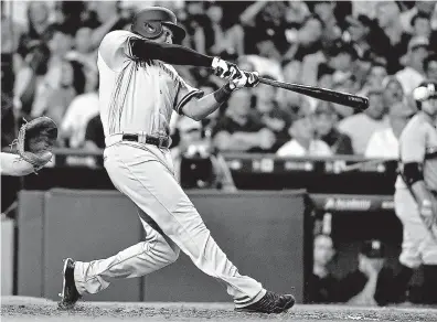  ?? Associated Press ?? New York Yankees’ Aaron Hicks hits a three-run triple during the fifth inning against the Houston Astros on Tuesday in Houston.