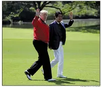  ?? AP/EVAN VUCCI ?? President Donald Trump and Japanese Prime Minister Shinzo Abe head for a round of golf today at Mobara Country Club south of Tokyo. Later, they were to sit ringside at a sumo wrestling match.