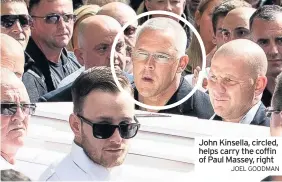  ?? JOEL GOODMAN ?? John Kinsella, circled, helps carry the coffin of Paul Massey, right