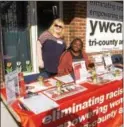  ?? EVAN BRANDT — DIGITAL FIRST MEDIA ?? Pauline McGibbon, left, legal advocate from the Pottstown office of the Women’s Center, and Ashley Faison, advocacy and volunteer manager for the YWCA Tri-County Area, welcome visitors to their open house Thursday during the Week Without Violence.