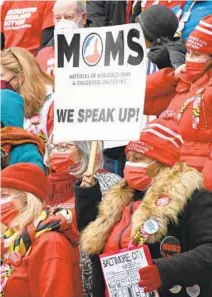  ?? PAMELA WOOD/BALTIMORE SUN ?? Denise Reid of Baltimore holds a sign for Moms of Murdered Sons and Daughters United at the State House Tuesday in support of a bill that would outlaw “ghost guns” in Maryland.