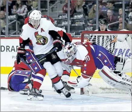  ?? ALEX BRANDON/ ASSOCIATED PRESS ?? Ottawa’s Kyle Turris crashes into Washingtro­n goalie Braden Holtby during the Senators’ loss Wednesday against the Capitals.