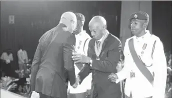  ??  ?? President David Granger (left) in 2015 congratula­ting Bryn Pollard SC on his national award of the Order of Roraima for his “contributi­ons in the field of law at the National, Regional, Commonweal­th and Internatio­nal levels.”