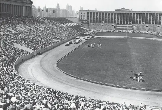  ?? RACINGONE/ISC IMAGES & ARCHIVES ?? Early stock car racing action at Soldier Field in 1952. The track hosted just one NASCAR Cup race in 1956 that was won by Fireball Roberts. Three NASCAR Convertibl­e Series events were held from 1956 through 1957 as well, with Chicago native Tom Pistone winning the first of those.