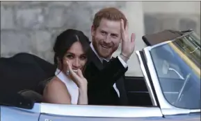  ?? STEVE PARSONS/POOL PHOTO VIA AP ?? The newly married Duke and Duchess of Sussex, Meghan Markle and Prince Harry, leave Windsor Castle in a convertibl­e car after their wedding in Windsor, England, to attend an evening reception at Frogmore House, hosted by the Prince of Wales, on Saturday.