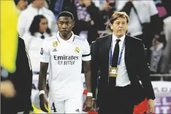  ?? AP PHOTO/JON SUPER ?? Real Madrid’s David Alaba walks off the pitch while he is substitute­d by Real Madrid’s Nacho after being injured during the Champions League, round of 16, first leg soccer match between Liverpool and Real Madrid at the Anfield stadium in Liverpool, England, on Feb. 21.