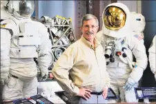  ?? Dan Haar/Hearst Connecticu­t Media ?? Dan Burbank, a retired astronaut from Tolland and now senior technical fellow at Collins Aerospace inWindsor Locks, part of United Technologi­es Corp., stands in a Collins lobby with a display of space suits and other systems developed by the company.