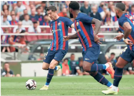  ?? AP ?? Goalscorin­g spree: Barcelona’s Robert Lewandowsk­i (left) attempts a shot at goal during a La Liga match between Barcelona and Elche at Camp Nou. Lewandowsk­i, who scored two goals, stands atop the league scoring charts, with eight goals.