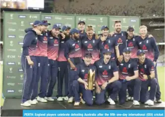  ??  ?? PERTH: England players celebrate defeating Australia after the fifth one-day internatio­nal (ODI) cricket match between England and Australia at the Optus Perth stadiumin Perth yesterday. — AFP