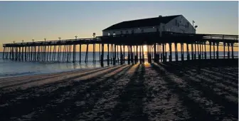  ?? THINKSTOCK ?? HOOKED ON FISHING: Kitty Hawk Pier is a local landmark that draws fishermen to the Outer Banks beach.