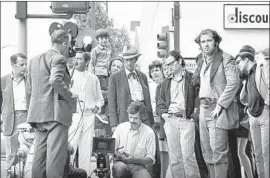  ?? AFI ?? CINEMATOGR­APHER Caleb Deschanel kneels in front of Harry Dean Stanton on the set of Terrence Malick’s 1970 thesis film. Malick is at right, hand on hip.