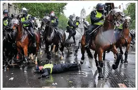  ??  ?? Down...officer unseated at BLM protest; main, England-Italy aftermath
