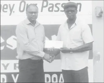  ??  ?? Sales Manager at Ganesh Parts, Suresh Rampersaud (left) hands over the sponsorshi­p to Chairman of the Boyce/Jefford Committee, Colin Boyce yesterday outside the Robb Street Store.