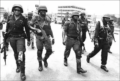  ??  ?? Members of a special police unit patrol the streets of Abuja as part of a special operation. (Photo: AFP)