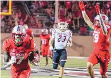  ?? ROBERTO E. ROSALES/ JOURNAL ?? University of New Mexico wide receiver Mannie LoganGreen­e, left, scores his first career touchdown on a pass from quarterbac­k Terry Wilson against rival New Mexico State on Saturday.