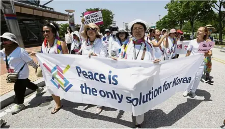  ?? — AP ?? Calling for peace: Activists marching towards the Dorasan Peace Park near Panmunjom in the Demilitari­sed Zone during the 2018 DMZ Women Peace Walk in Paju, South Korea.