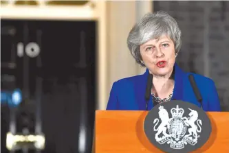  ?? Reuters-Yonhap ?? Britain’s Prime Minister Theresa May makes a statement following winning a confidence vote, after Parliament rejected her Brexit deal, outside 10 Downing Street in London, Britain, Wednesday.