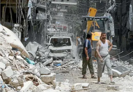  ?? PHOTO: REUTERS ?? Residents inspect the damage after an air strike on Aleppo’s rebel held al-Mashad neighbourh­ood.