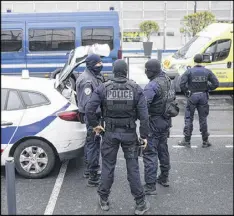  ?? AP ?? French police forces stand outside Orly Airport, south of Paris, on Saturday. Soldiers shot and killed a man who wrestled one of their colleagues to the ground and tried to steal her rifle, officials said.