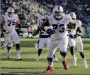  ?? SETH WENIG - THE ASSOCIATED PRESS ?? FILE - In this Nov. 11, 2018file photo Buffalo Bills offensive tackle Dion Dawkins (73) scores a touchdown against the New York Jets during the second quarter of an NFL football game in East Rutherford, N.J.