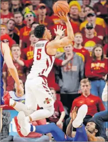  ?? [CHARLIE NEIBERGALL/THE ASSOCIATED PRESS] ?? Iowa State guard Lindell Wigginton shoots over Kansas guard K.J. Lawson during the second half of the Cyclones’ 77-60 victory.