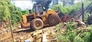  ?? KRATIE PROVINCIAL MINE AND ENERGY DEPARTMENT ?? A bulldozer dismantles an illegal gold mine shaft.