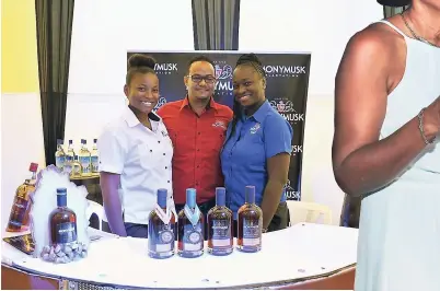  ??  ?? Damian Graveley, commercial manager of National Rums of Jamaica, is flanked by commercial manager Amoy Cousins (right) and promoter Civan Rowe.