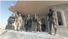  ?? ALSAYED/AP GHAITH ?? Turkish-backed Syrian rebels enter the town of Saraqeb, in Idlib province, Syria, on Thursday. The opposition fighters retook the strategic town, opposition activists said, and cut off a key highway days after the government reopened it.